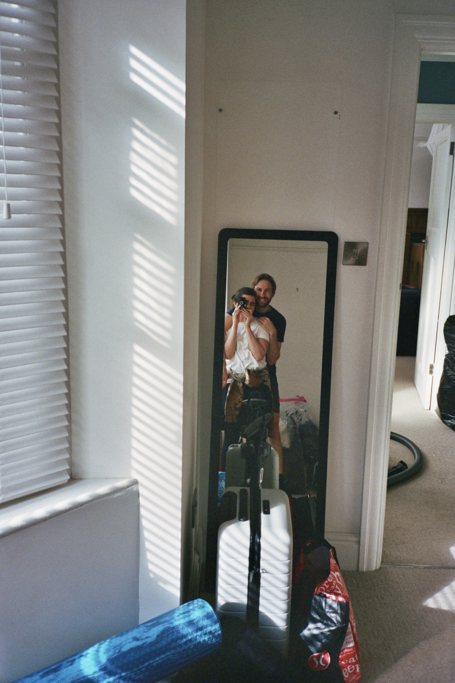 A selfie of Anna and Mark in front of their mirror and packing boxes.