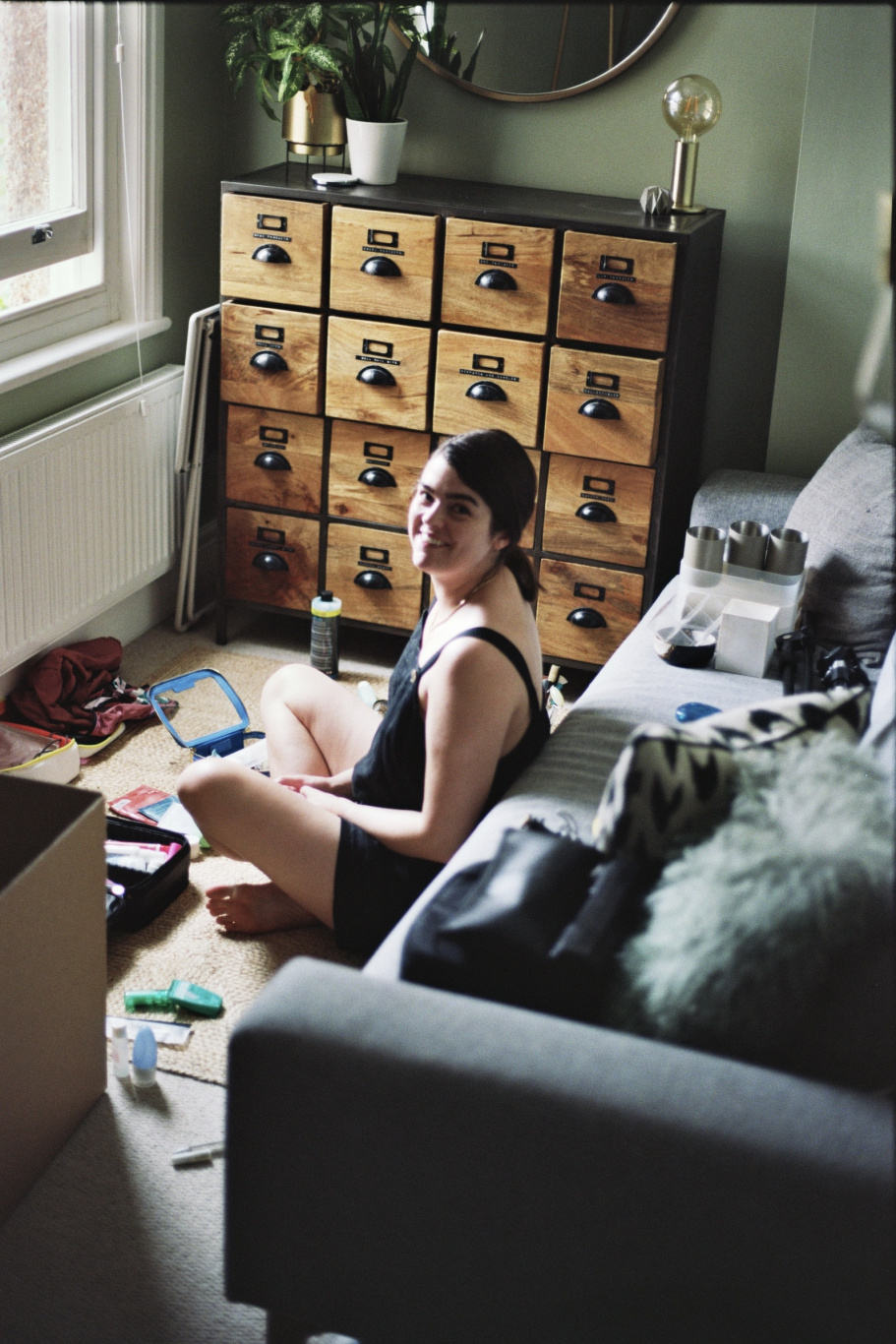 A photo of Anna in the office, packing up her beauty supplies.